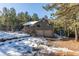 Two-story home with a three-car garage and snow-covered landscaping at 746 Bow Mountain Rd, Boulder, CO 80304