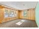 Living room with wood paneled walls and carpeted floors at 746 Bow Mountain Rd, Boulder, CO 80304