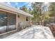 Snow covered deck with wooden railings and sliding glass door access at 746 Bow Mountain Rd, Boulder, CO 80304