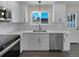 Modern kitchen with white cabinets, stainless steel appliances, and quartz countertops at 762 S Simms St, Lakewood, CO 80228