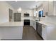 Modern kitchen with stainless steel appliances and white shaker cabinets at 762 S Simms St, Lakewood, CO 80228