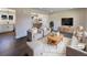 Virtually staged living room features modern furniture and dark hardwood floors at 762 S Simms St, Lakewood, CO 80228