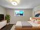 Virtually staged main bedroom with a modern bed and neutral decor at 762 S Simms St, Lakewood, CO 80228