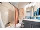 Modern bathroom with a tub, shower, and a double vanity at 3958 N Riviera Ct, Aurora, CO 80019