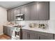 Modern kitchen with gray cabinets and white countertops at 3958 N Riviera Ct, Aurora, CO 80019