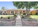 Brick ranch home with landscaped yard and walkway at 8931 Hoffman Way, Thornton, CO 80229