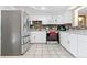 Bright kitchen with white cabinets, stainless steel appliances, and granite countertops at 8931 Hoffman Way, Thornton, CO 80229