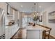 Bright kitchen, featuring white cabinets and an expansive island at 15625 E Broncos Pl, Centennial, CO 80112