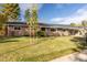 Ranch-style brick home with a well-manicured lawn at 545 S Harrison Ln, Denver, CO 80209