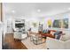 Open living room and dining area with hardwood floors and modern furniture at 545 S Harrison Ln, Denver, CO 80209