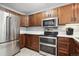 Kitchen with stainless steel appliances and wood cabinets at 5157 E Weaver Pl, Centennial, CO 80121