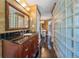 Bathroom with dark tile floors, glass block shower, and a modern vanity at 10987 Roxborough Dr, Littleton, CO 80125