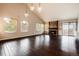 Open living room with hardwood floors, stone fireplace, and slider to patio at 3779 S Cathay Cir, Aurora, CO 80013