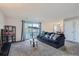 Living room with comfy sofa, carpet, and access to patio at 2201 Sable Blvd # 1008, Aurora, CO 80011