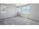 Bright bedroom with large windows and carpet flooring at 3292 N Highlands Creek Pkwy, Aurora, CO 80019