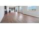 Open concept living room, kitchen and dining area with wood-look floors at 3292 N Highlands Creek Pkwy, Aurora, CO 80019