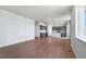 Open concept living room and kitchen area with wood-look floors at 3292 N Highlands Creek Pkwy, Aurora, CO 80019