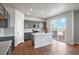 Modern kitchen with grey cabinetry, island, and stainless steel appliances at 3292 N Highlands Creek Pkwy, Aurora, CO 80019