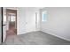 Bright bedroom with carpet flooring and a door to hallway at 3292 N Highlands Creek Pkwy, Aurora, CO 80019