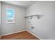 Bright laundry room with built-in shelving and window at 3292 N Highlands Creek Pkwy, Aurora, CO 80019