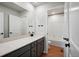 Clean bathroom with single vanity, tub, and neutral tile at 3292 N Highlands Creek Pkwy, Aurora, CO 80019