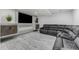 Finished basement media room featuring a large sectional sofa and built-in entertainment center at 12451 Pass Me By Rd, Strasburg, CO 80136