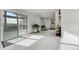 Sunlit entryway with sliding glass door to deck and built-in shelving at 12451 Pass Me By Rd, Strasburg, CO 80136