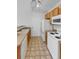 Bright kitchen with wood cabinets, white appliances, and a convenient pass-through at 22975 E Ontario Dr # 101, Aurora, CO 80016