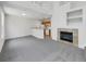 Open living room with a fireplace and high ceilings, perfect for entertaining at 22975 E Ontario Dr # 101, Aurora, CO 80016