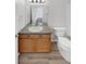 Clean bathroom with wood vanity, double sinks, and a toilet at 22975 E Ontario Dr # 101, Aurora, CO 80016