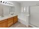 Main bathroom with double sinks, bathtub and shower at 22975 E Ontario Dr # 101, Aurora, CO 80016