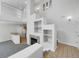 Two-story living room with a fireplace and built-in shelving at 22975 E Ontario Dr # 101, Aurora, CO 80016