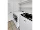 Laundry room with washer, dryer, and overhead shelving at 22975 E Ontario Dr # 101, Aurora, CO 80016