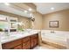 Bathroom with double vanity and a large soaking tub at 4505 S Yosemite S St # 371, Denver, CO 80237
