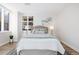 Bright bedroom with hardwood floors, neutral walls, and ample natural light at 1133 Race St # 1B, Denver, CO 80206