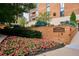 Huntington House entrance with a brick wall and flower bed at 1133 Race St # 1B, Denver, CO 80206