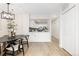 Modern dining area with an open kitchen concept, featuring a stylish chandelier at 1133 Race St # 1B, Denver, CO 80206