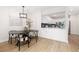 Elegant dining room features a black table and chairs, open to the kitchen at 1133 Race St # 1B, Denver, CO 80206