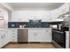 Bright kitchen with white cabinets, stainless steel appliances, and a quartz countertop at 1133 Race St # 1B, Denver, CO 80206