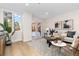 Living room with sliding doors to a private patio, featuring a modern and airy design at 1133 Race St # 1B, Denver, CO 80206