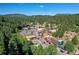 Aerial view of a charming town nestled in a mountain valley at 7142 Lynx Lair Rd, Evergreen, CO 80439