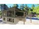 Modern home exterior with stone and wood features, a deck and mountain views at 7142 Lynx Lair Rd, Evergreen, CO 80439