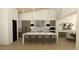 Modern kitchen with large island, wood cabinets and a spacious dining area at 7142 Lynx Lair Rd, Evergreen, CO 80439