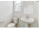 Clean and bright bathroom with pedestal sink and toilet at 9374 Bahama Ct, Commerce City, CO 80022