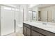Modern bathroom with double vanity, marble countertops and large shower at 9374 Bahama Ct, Commerce City, CO 80022