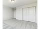 Bright bedroom with double doors leading to a closet and carpeted floor at 9374 Bahama Ct, Commerce City, CO 80022