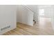 Light wood flooring, white walls, staircase and view into living room at 9374 Bahama Ct, Commerce City, CO 80022