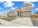 Two-story house with gray siding, stone accents, and a two-car garage at 9374 Bahama Ct, Commerce City, CO 80022