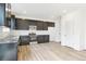 Modern kitchen with dark cabinetry, granite counters, and stainless steel appliances at 9374 Bahama Ct, Commerce City, CO 80022
