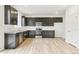 Modern kitchen with dark cabinetry, granite counters, and stainless steel appliances at 9374 Bahama Ct, Commerce City, CO 80022
